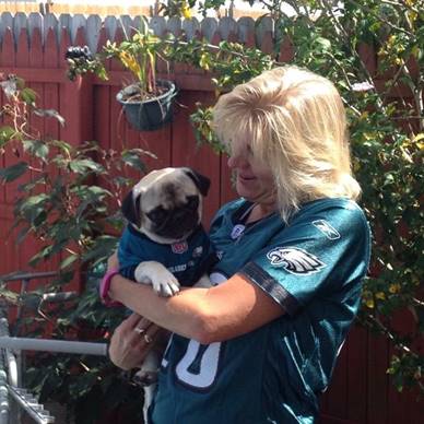 Patty celebrating her favorite football team with her dog 
