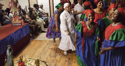 This photo shows a joyful group of women participating in a ceremony in Brooklyn, New York.